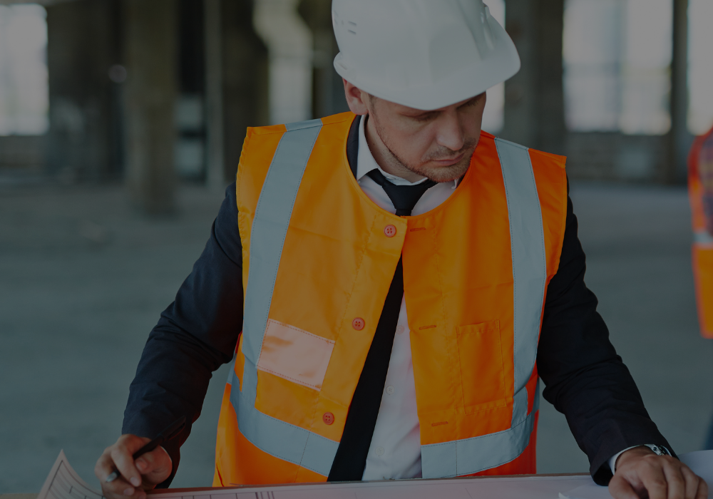 Construction worker looking at building plans