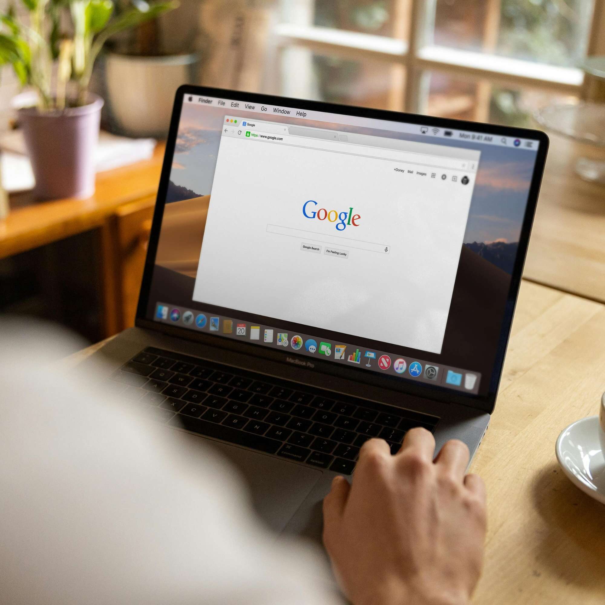 Person using a laptop to research generative engine optimization strategies